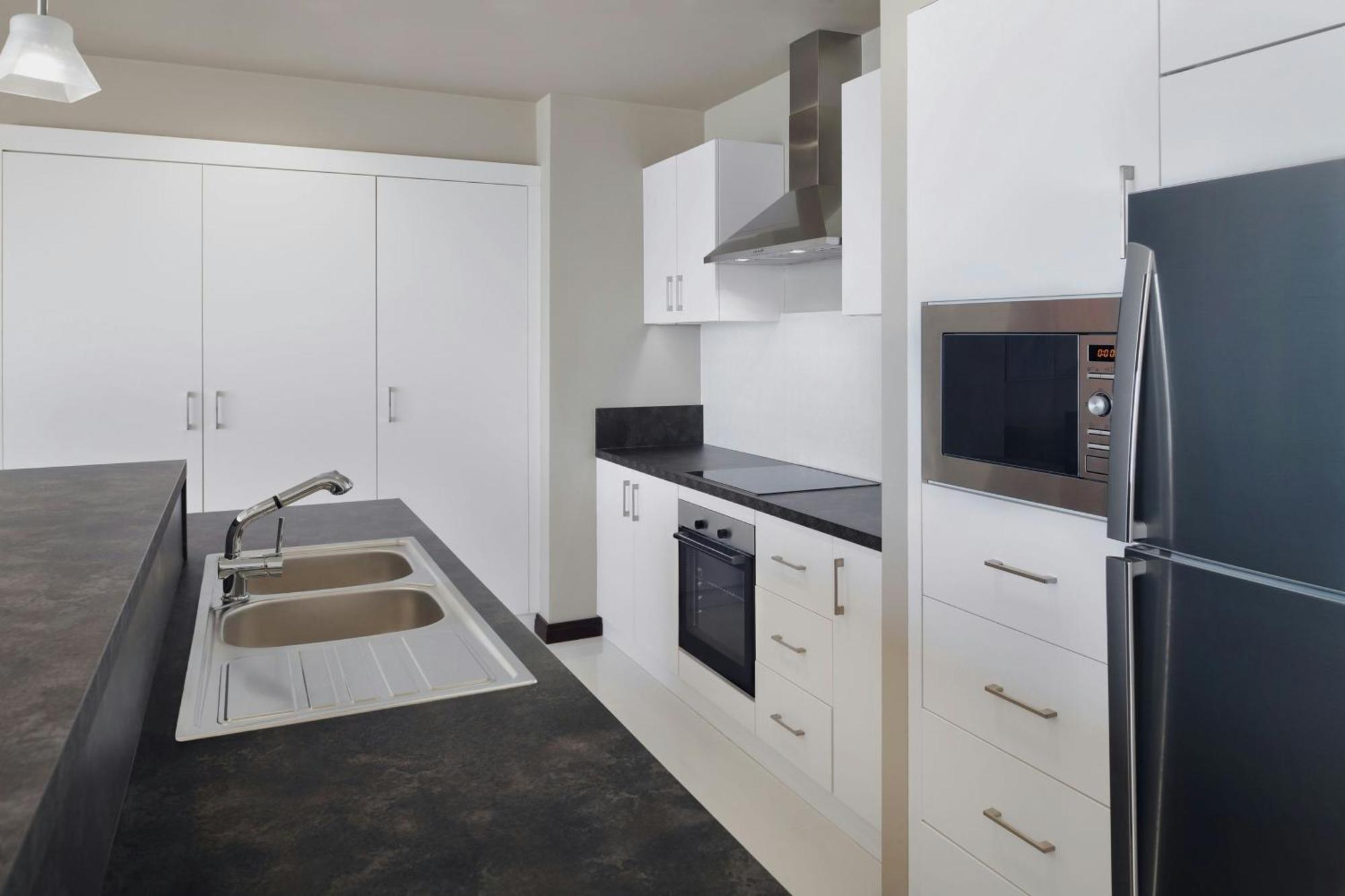 Delta Hotels By Marriott City Center Doha Bagian luar foto A typical kitchen in a student apartment