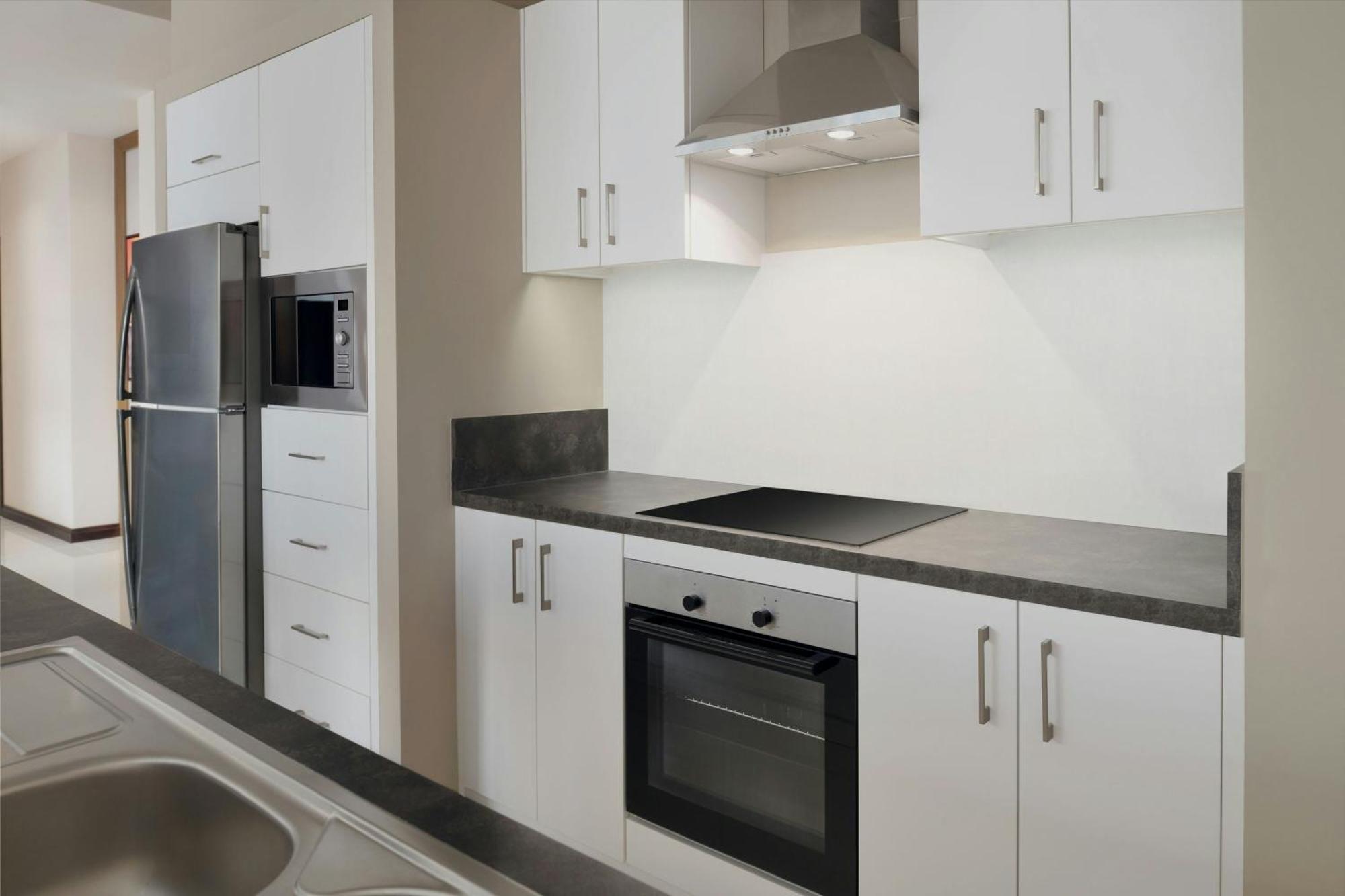 Delta Hotels By Marriott City Center Doha Bagian luar foto A typical kitchen in a student apartment